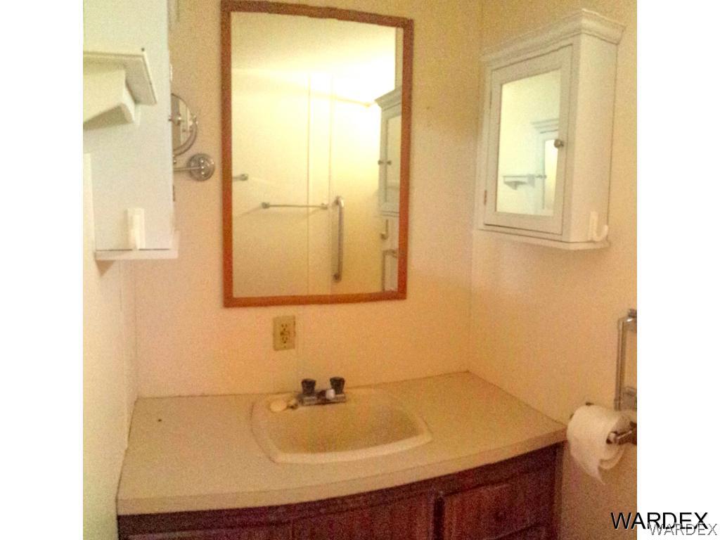 3865 Aztec Road Golden Valley, AZ 86413 - Photo 11 of 26 a bathroom with a sink and a mirror
