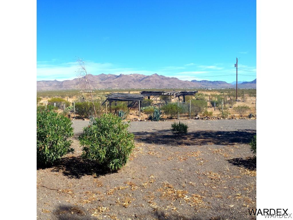 3865 Aztec Road Golden Valley, AZ 86413 - Photo 17 of 26 a view of a lake with a mountain