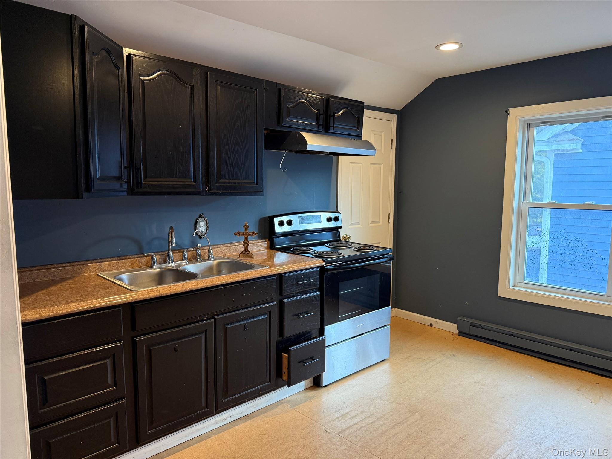 115 Innis Avenue Poughkeepsie, NY 12601 - Photo 16 of 28 2nd Kitchen featuring electric stove, vaulted ceiling, dark cabinetry, under cabinet range hood, and light floors