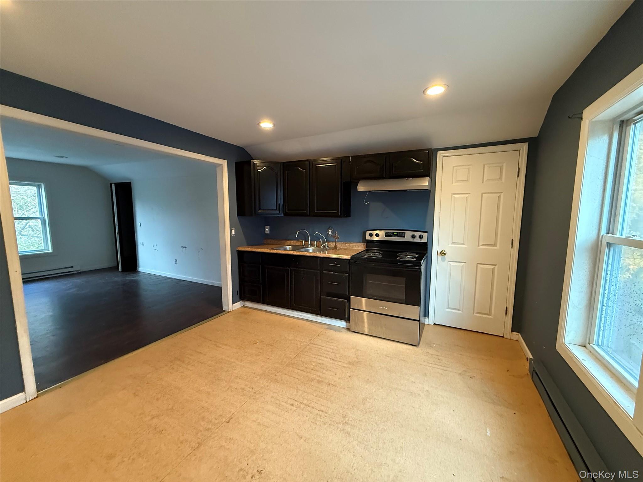 115 Innis Avenue Poughkeepsie, NY 12601 - Photo 23 of 28 Kitchen featuring a baseboard heating unit, electric range, light countertops, recessed lighting, and dark cabinetry
