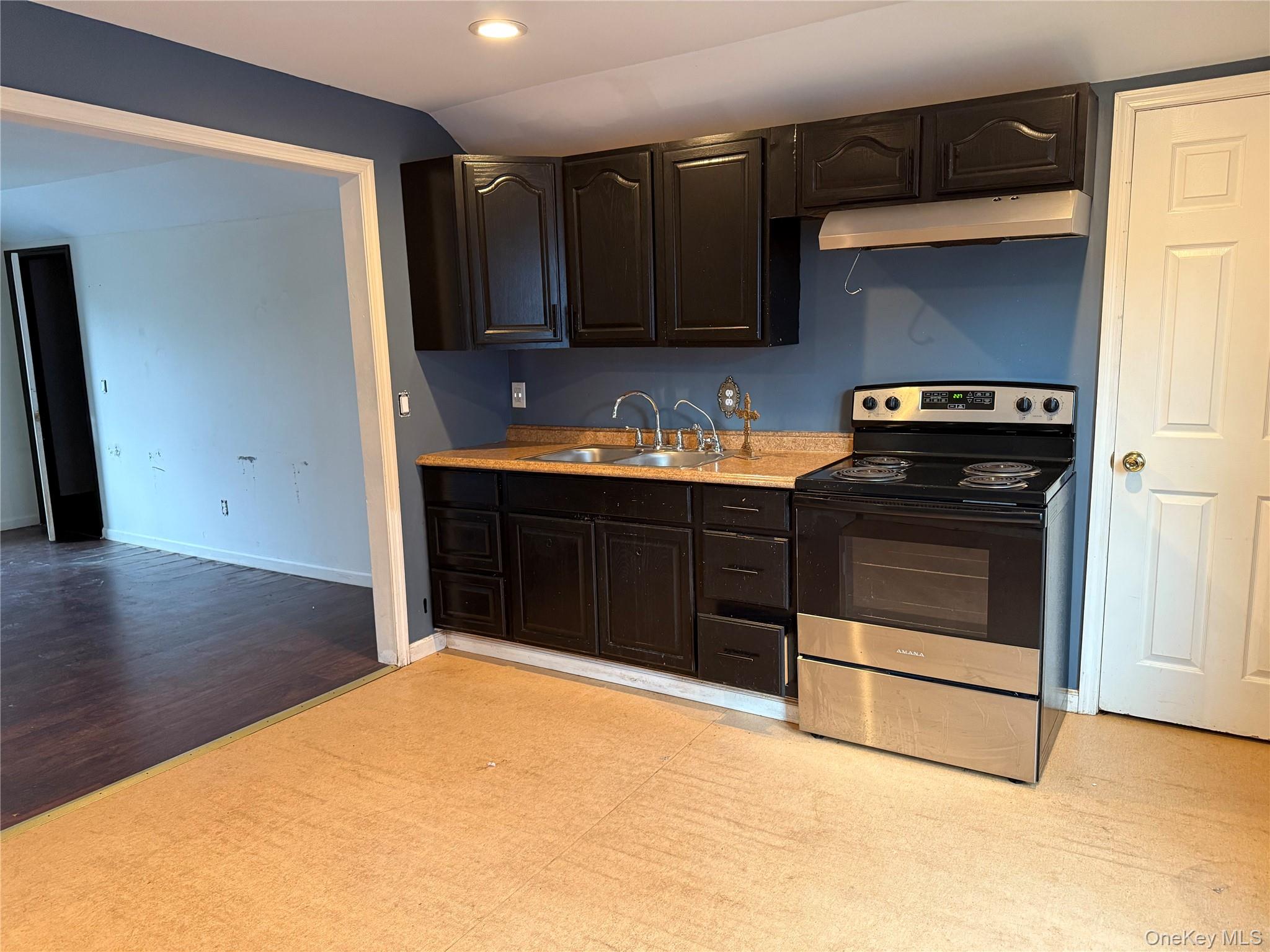 115 Innis Avenue Poughkeepsie, NY 12601 - Photo 24 of 28 Kitchen featuring stainless steel electric stove, under cabinet range hood, recessed lighting, light countertops, and dark brown cabinetry