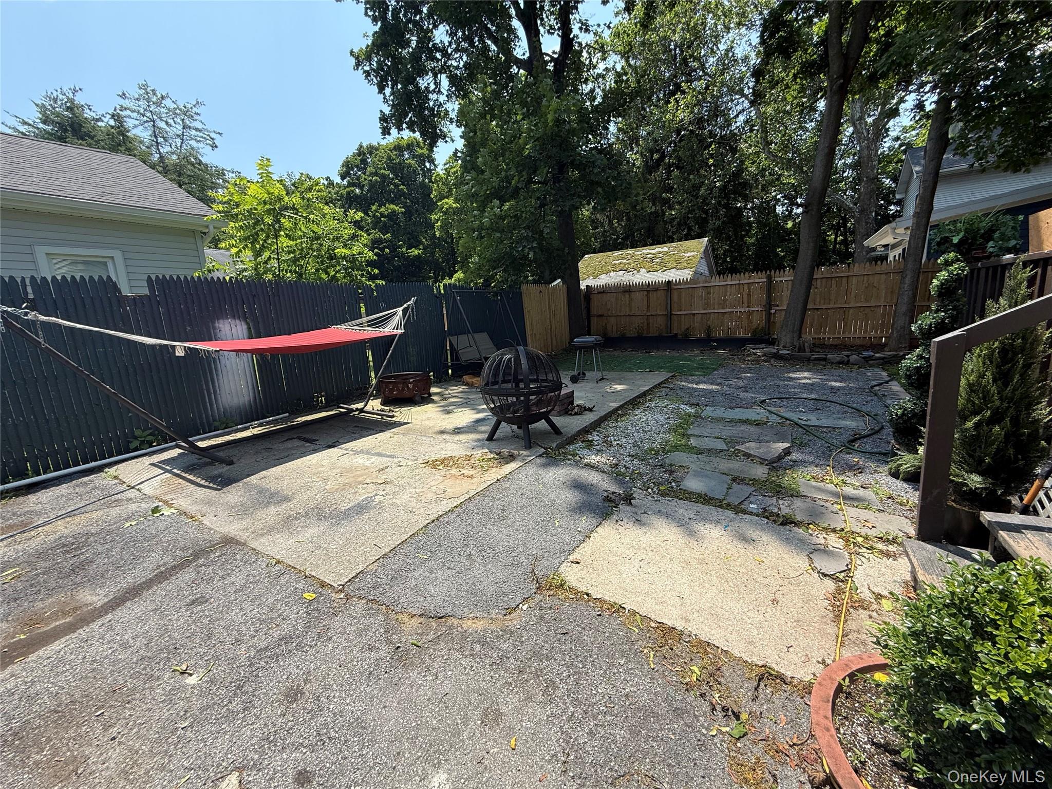 115 Innis Avenue Poughkeepsie, NY 12601 - Photo 4 of 28 Fenced backyard featuring a patio area and an outdoor fire pit