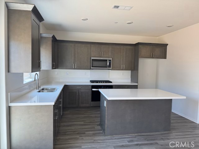8284 Perada Street Jurupa Valley, CA 92509 - Photo 2 of 3 a kitchen with kitchen island stainless steel appliances a sink and a refrigerator