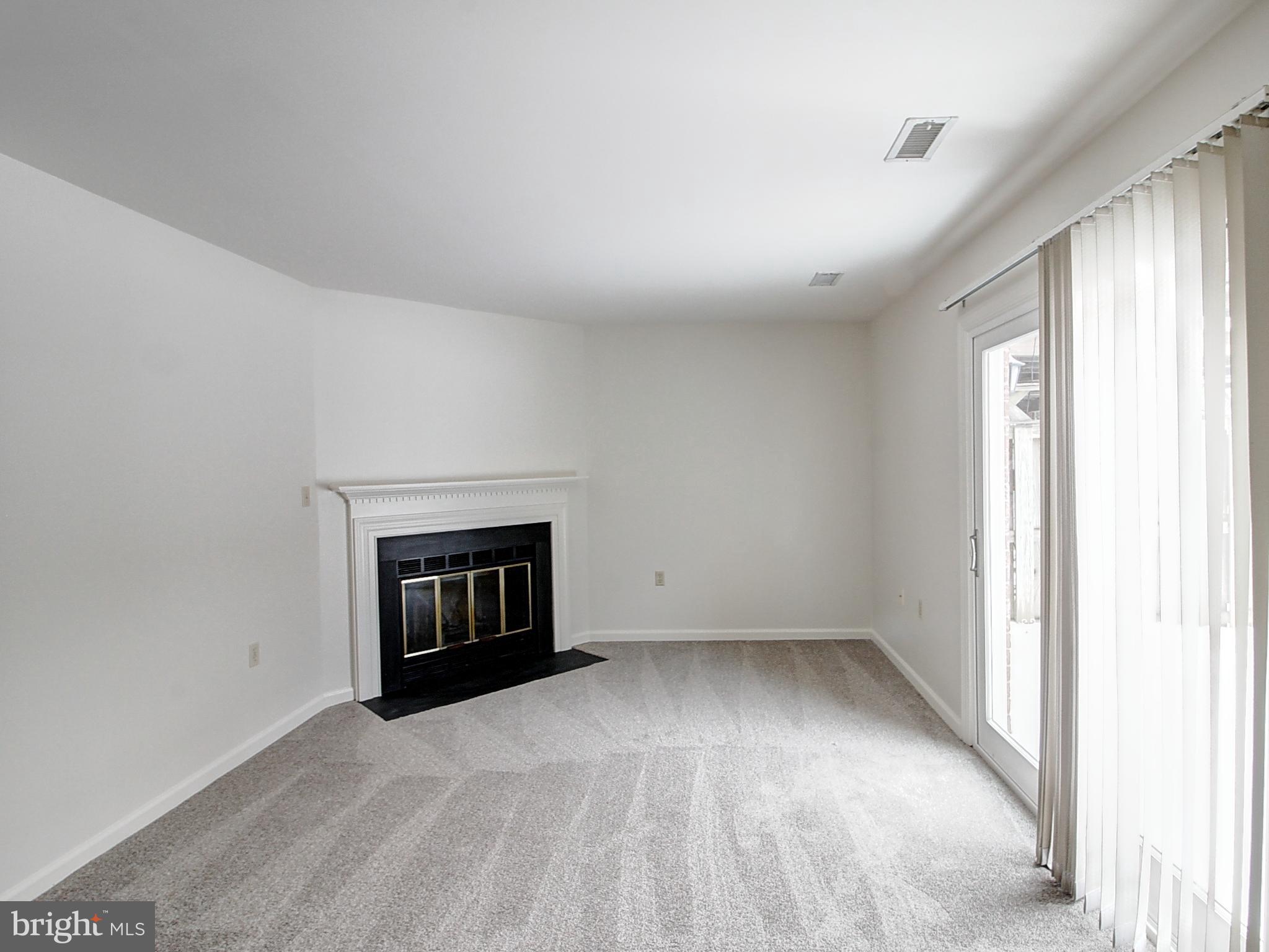 7990 Quay Court Frederick, MD 21701 - Photo 14 of 16 a view of an empty room with a fireplace and a window