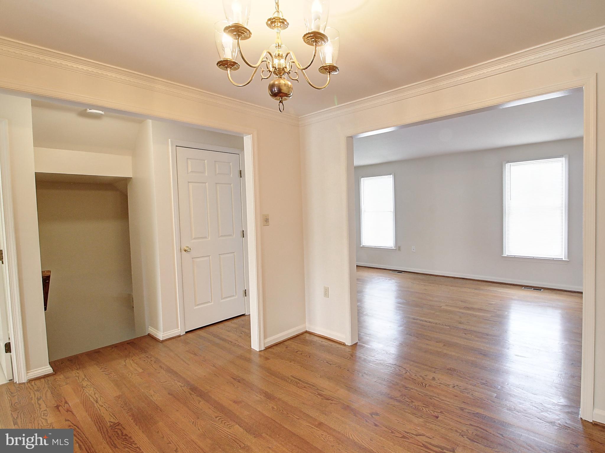 7990 Quay Court Frederick, MD 21701 - Photo 6 of 16 a view of an empty room with wooden floor and a window