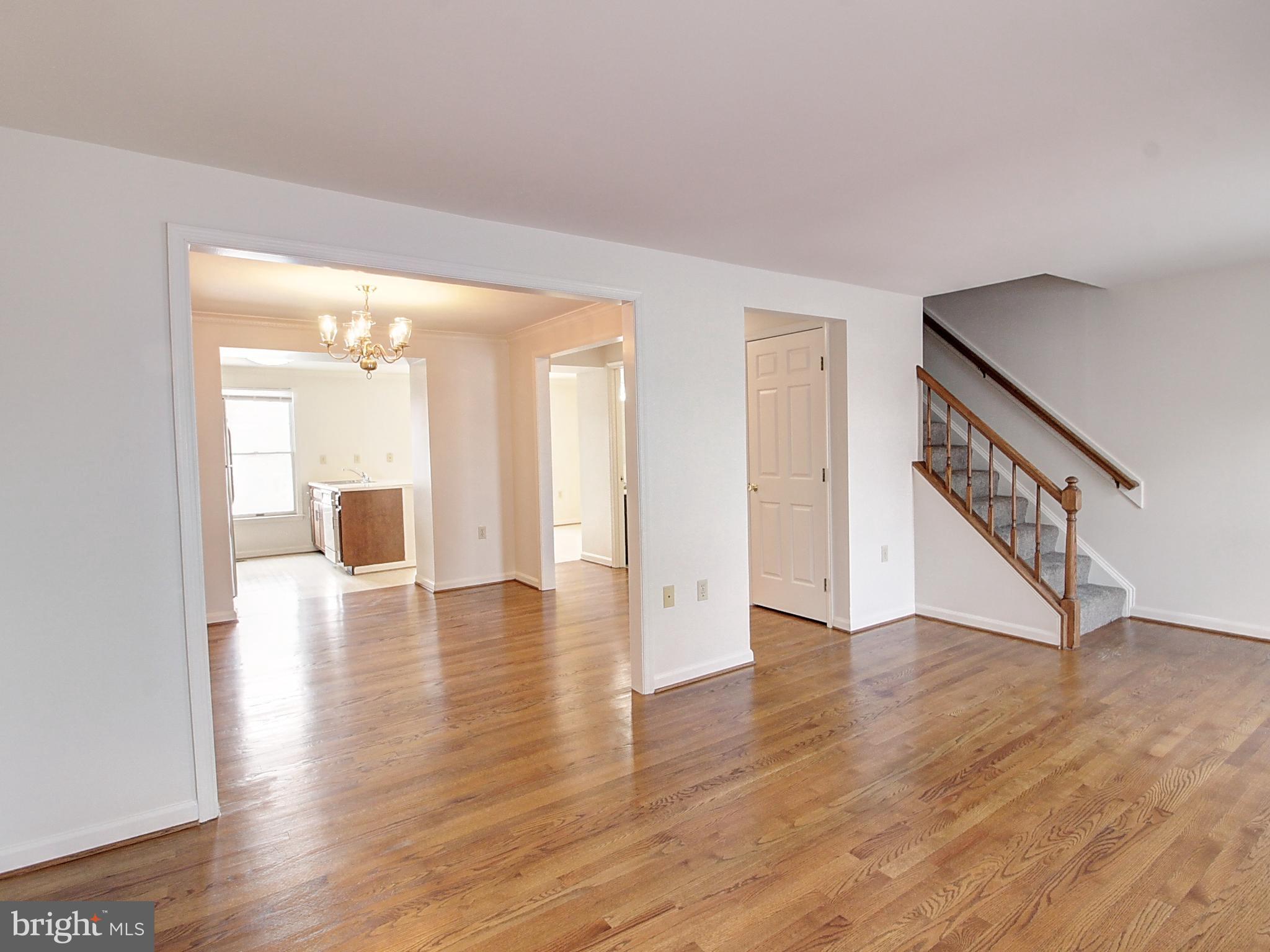 7990 Quay Court Frederick, MD 21701 - Photo 7 of 16 a view of an empty room with wooden floor and a large window