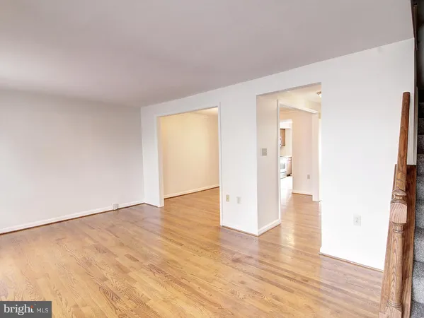 a view of an empty room and wooden floor
