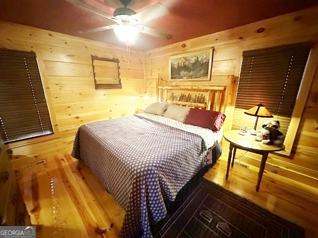 5559 Mill Creek Church Road Mitchell, GA 30820 - Photo 17 of 65 a bedroom with a bed and wooden floor
