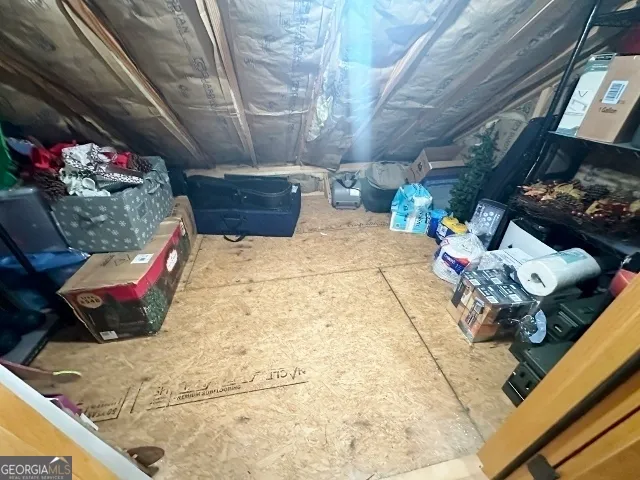 a view of a patio with table and chairs with wooden floor and fence