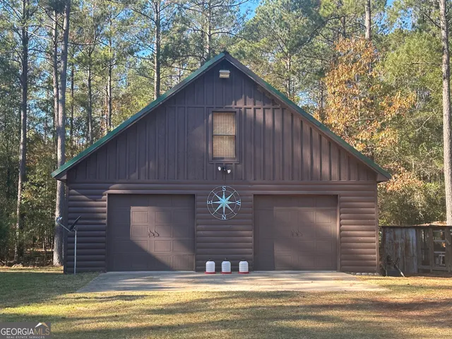 a view of swimming pool with outdoor seating and trees in the background