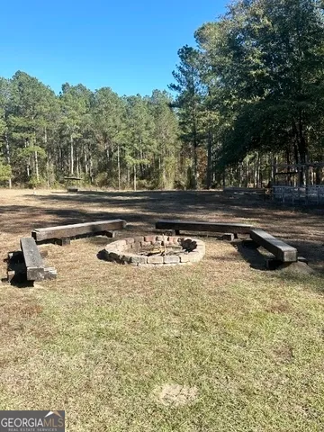 a view of a field with trees in the background