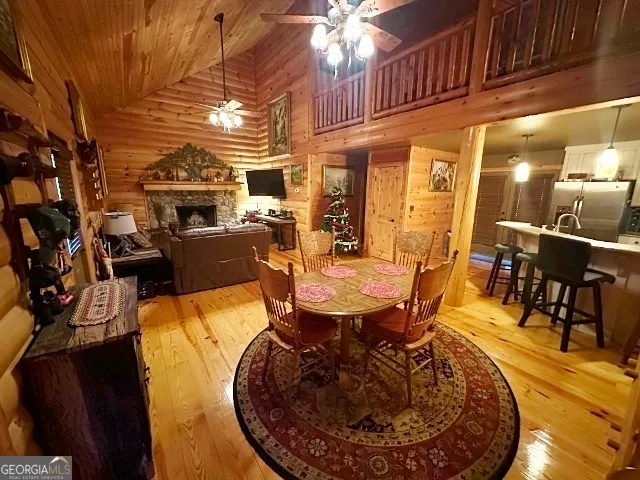 a kitchen with kitchen island granite countertop a table chairs microwave and refrigerator