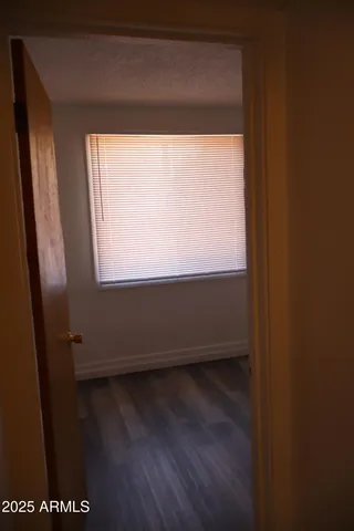 a view of a small space with wooden floor and a window