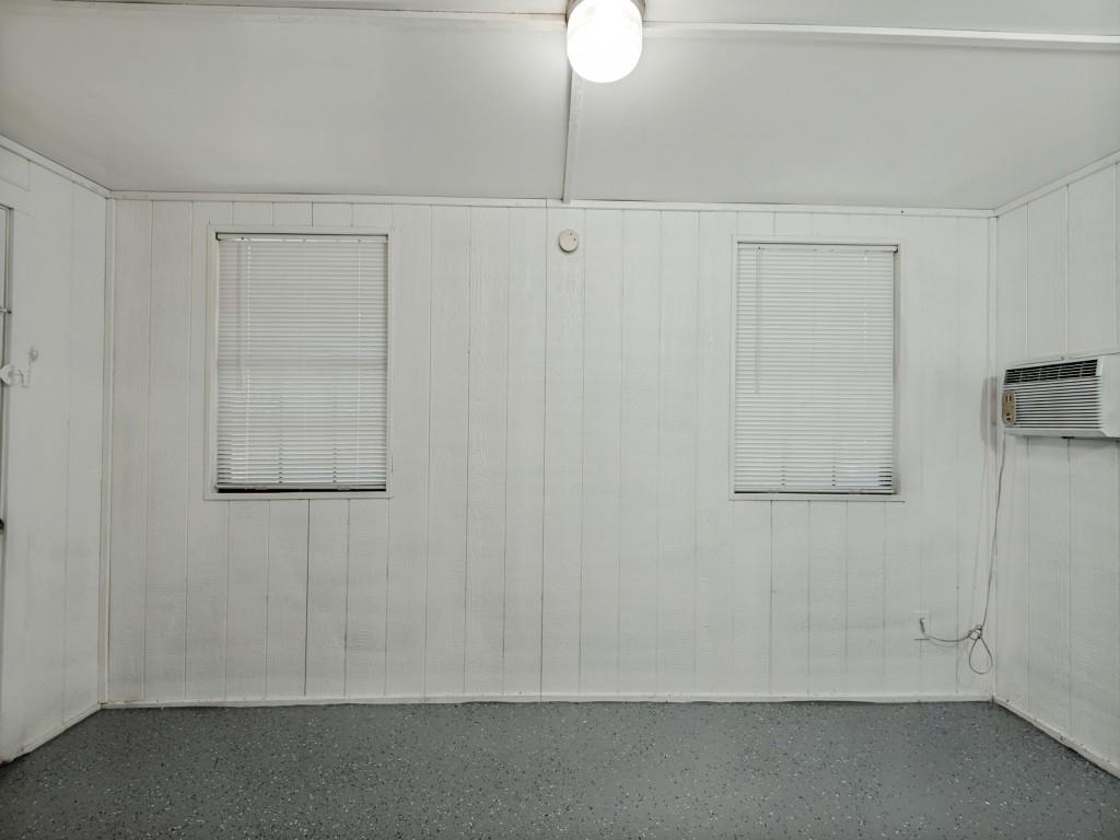 3716 Royal Valley Road Grand Prairie, TX 75052 - Photo 11 of 25 Paneling walls, recessed lighting, and window-mounted air conditioning unit