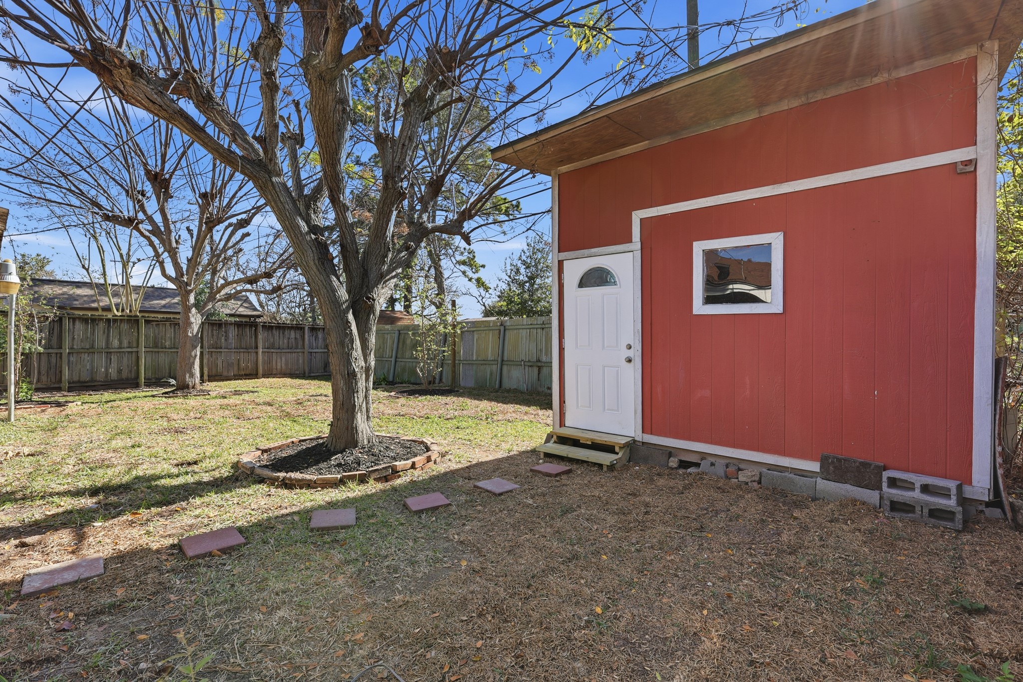 2716 Windsor Lane Pasadena, TX 77506 - Photo 19 of 22 a view of a backyard with a tree