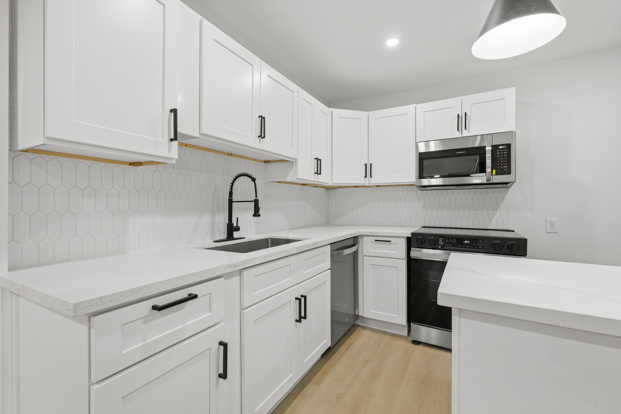 2716 Windsor Lane Pasadena, TX 77506 - Photo 6 of 22 a kitchen with white cabinets and white appliances