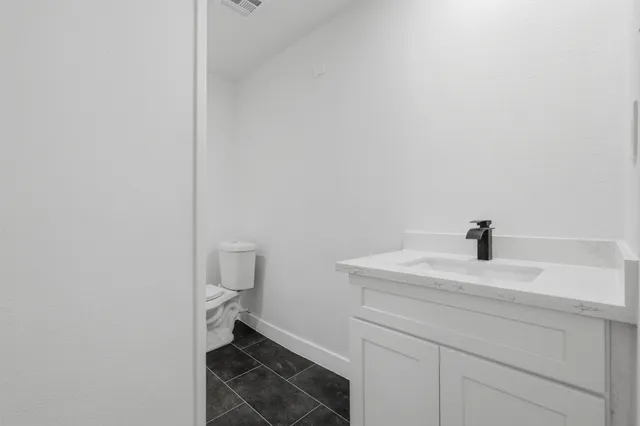 a bedroom with a bed a window and painting on the wall