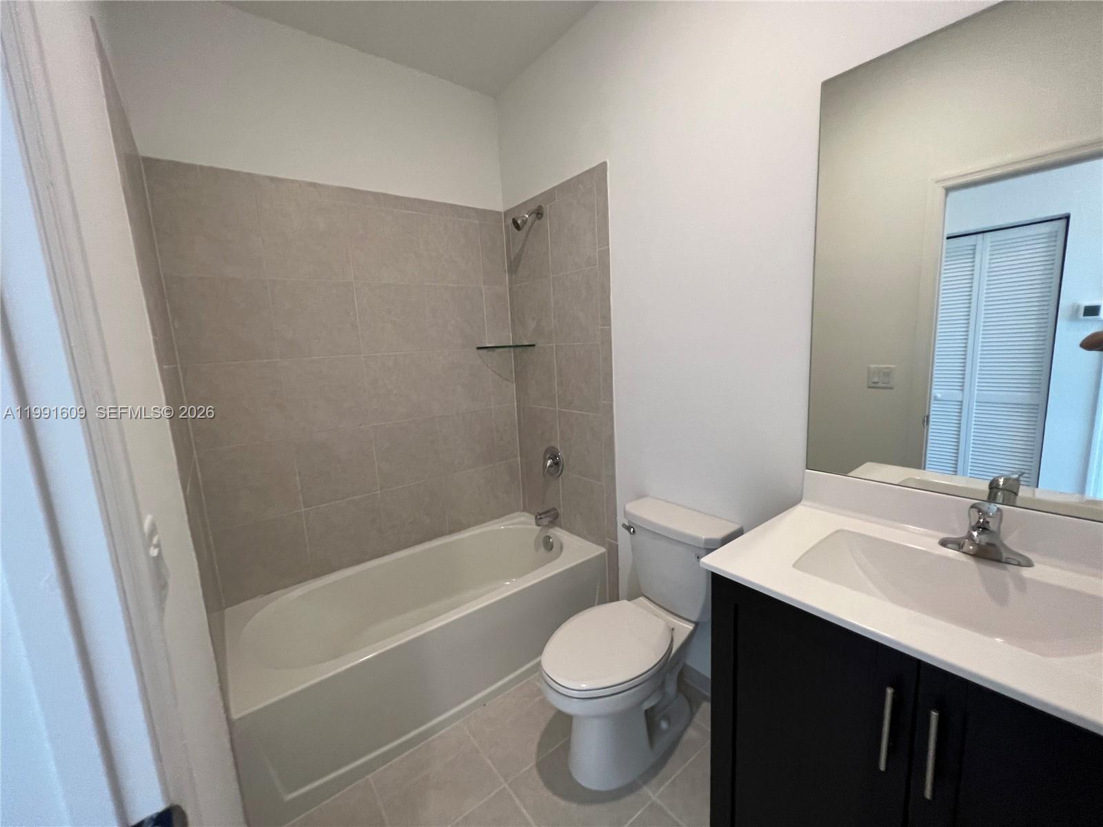 1864 Southeast 27th Street, Unit 1864 Homestead, FL 33035 - Photo 13 of 17 a bathroom with a sink a toilet and shower