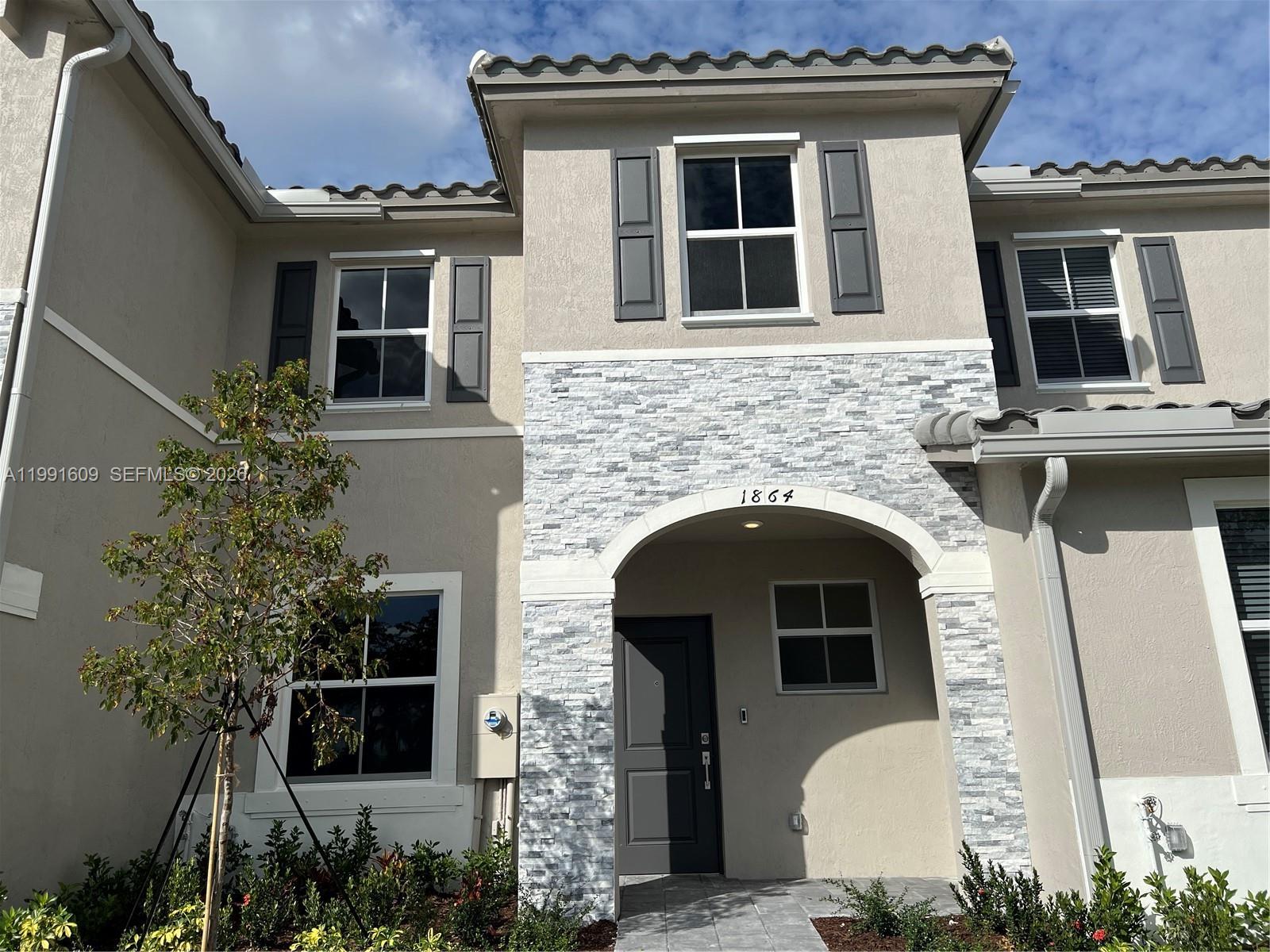 1864 Southeast 27th Street, Unit 1864 Homestead, FL 33035 - Photo 14 of 17 a front view of a house with plants