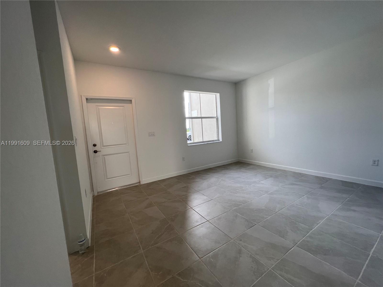 1864 Southeast 27th Street, Unit 1864 Homestead, FL 33035 - Photo 6 of 17 an empty room with windows