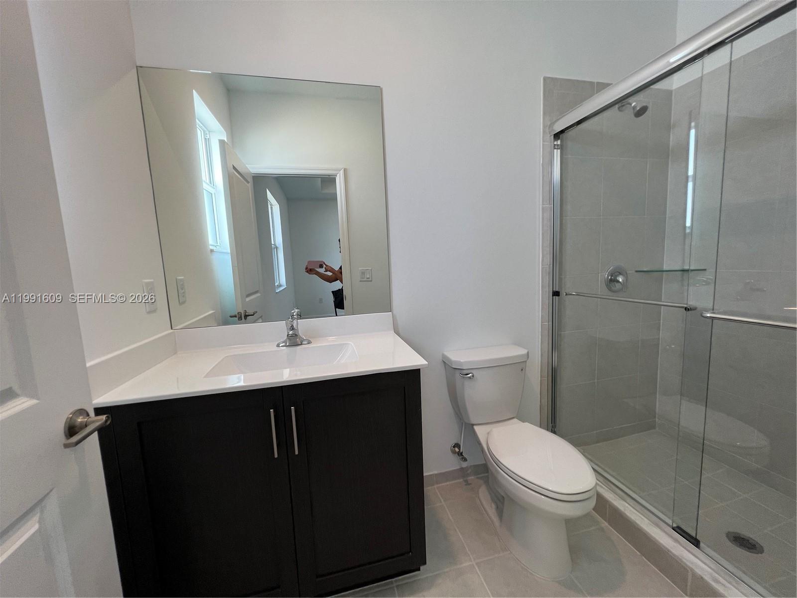 1864 Southeast 27th Street, Unit 1864 Homestead, FL 33035 - Photo 9 of 17 a bathroom with a sink a toilet and shower