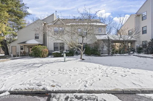 a view of a house with a snow in the yard