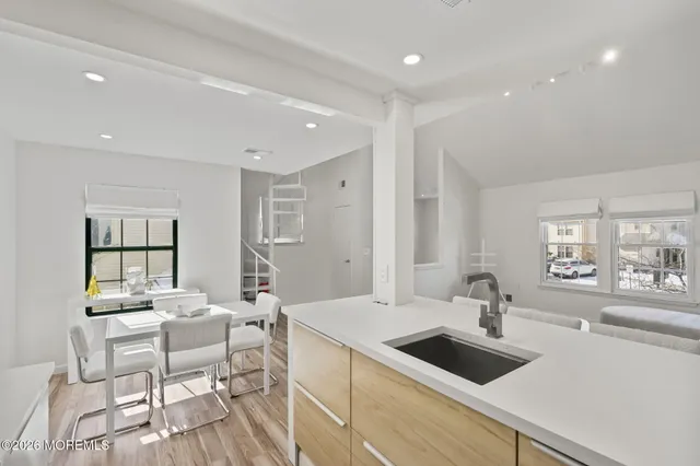a bathroom with a granite countertop sink a toilet and bathtub