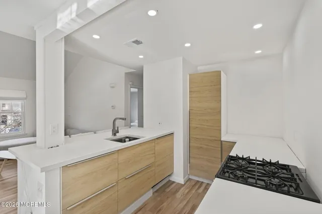 a kitchen with a sink and living room