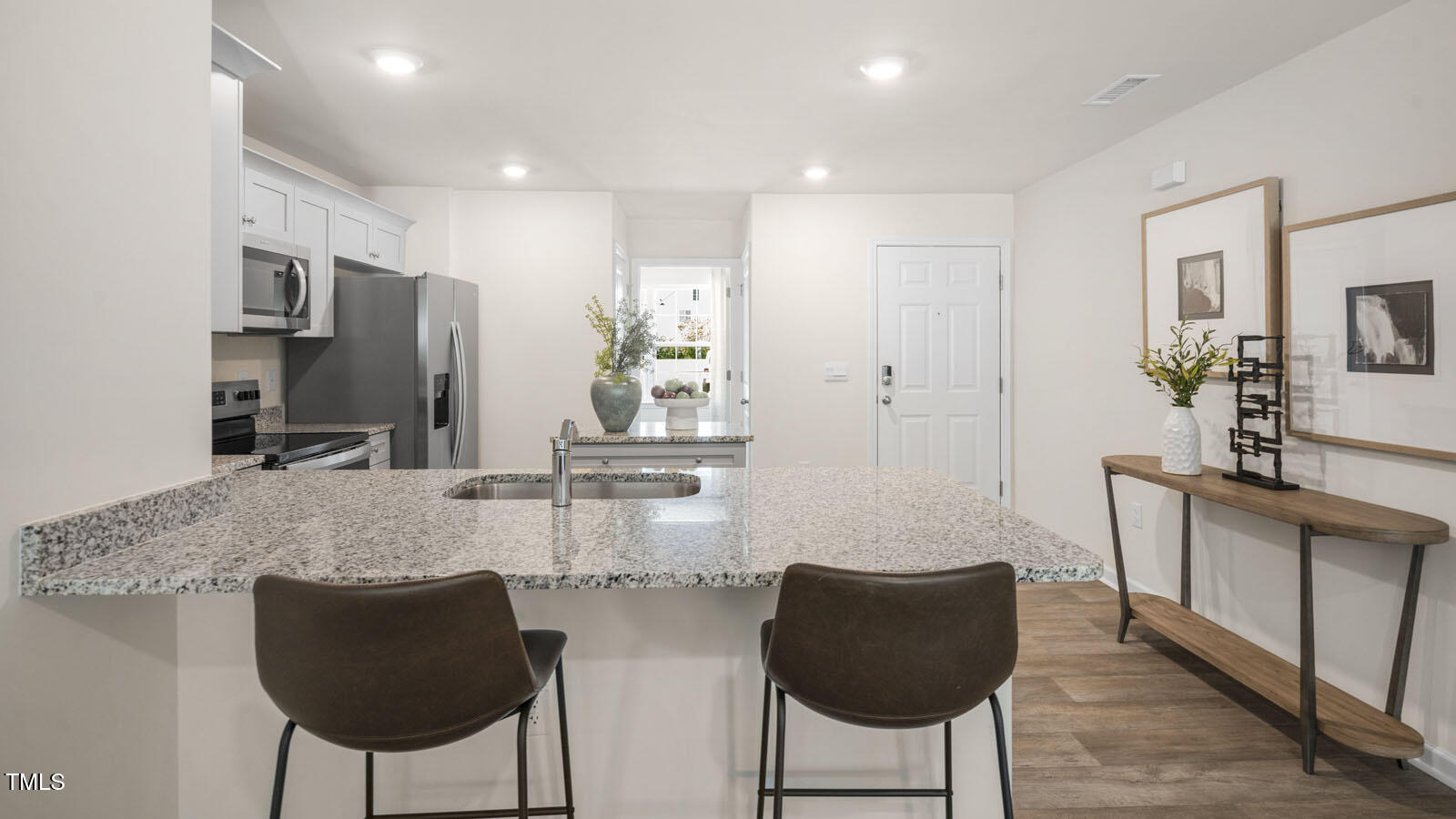 8517 Beckett Chase Way Raleigh, NC 27616 - Photo 12 of 31 a kitchen with stainless steel appliances granite countertop a refrigerator and a coffee table
