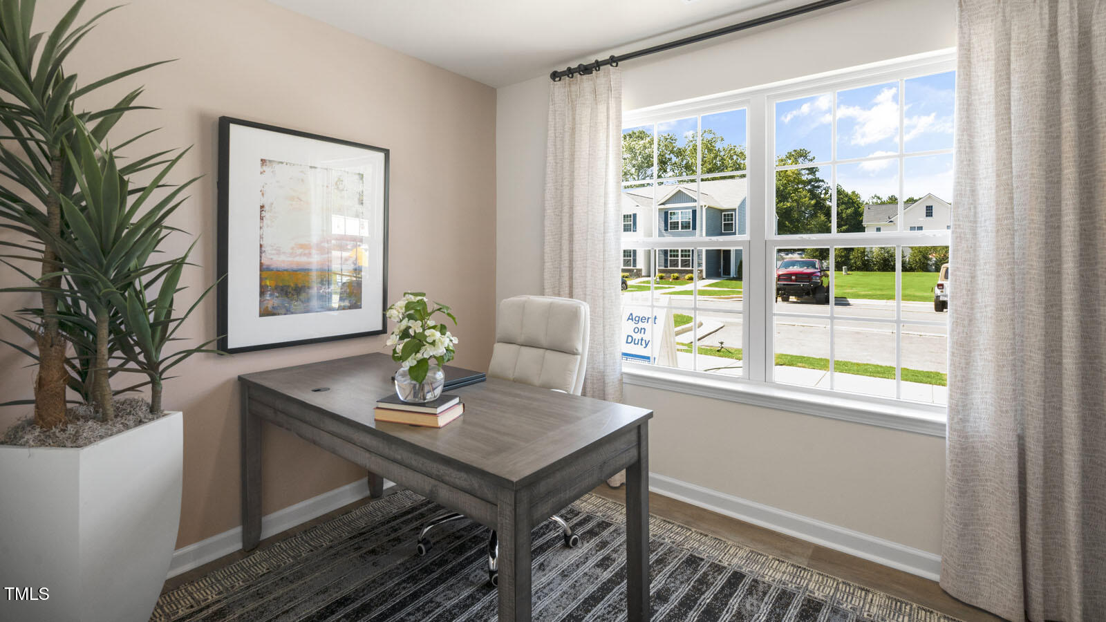 8517 Beckett Chase Way Raleigh, NC 27616 - Photo 3 of 31 a view of a workspace with furniture and a window