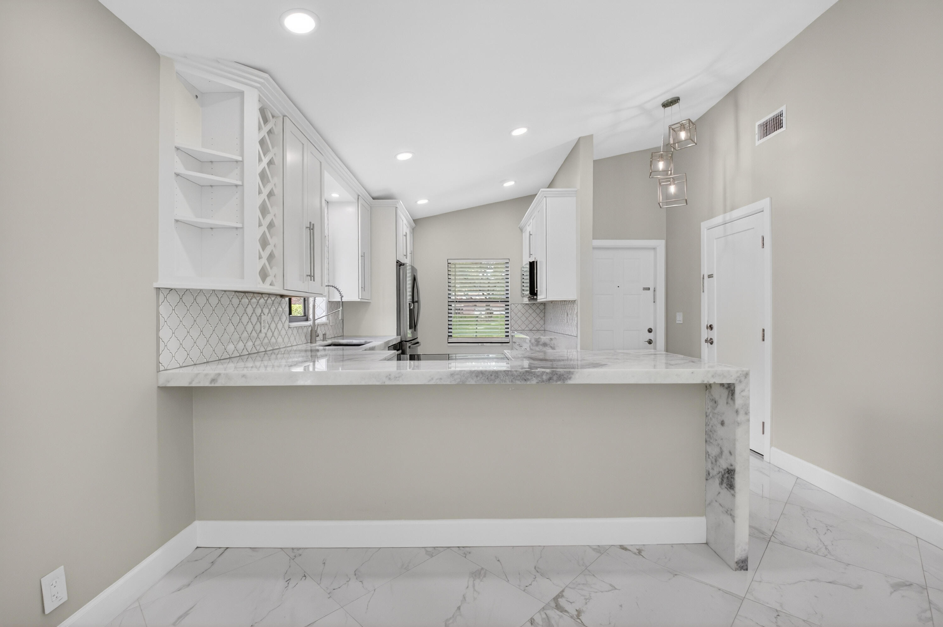 8216 Sweetbriar Way Boca Raton, FL 33496 - Photo 16 of 56 a kitchen with kitchen island sink stove and cabinets