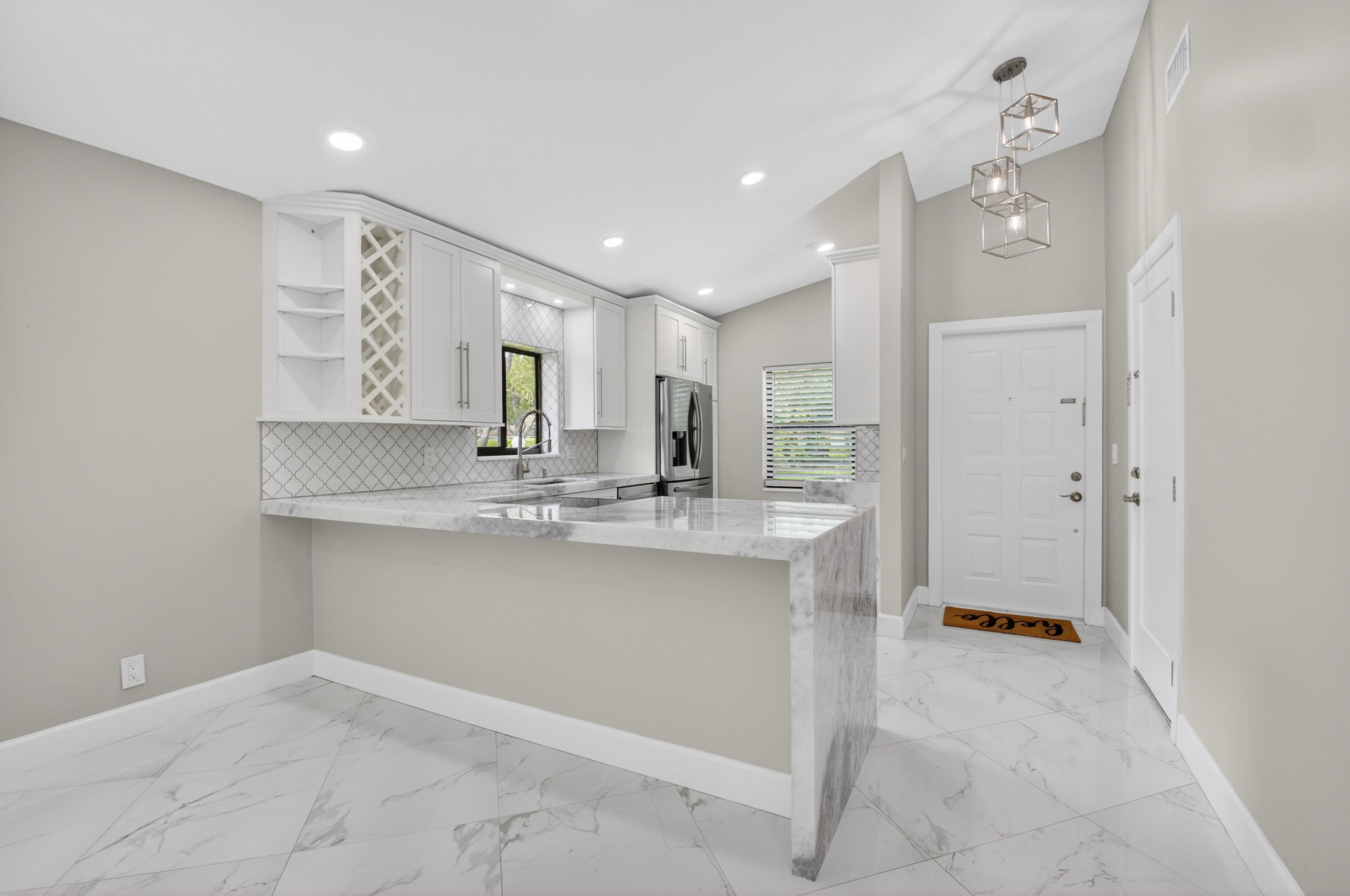 8216 Sweetbriar Way Boca Raton, FL 33496 - Photo 17 of 56 a large kitchen with a sink and chandelier