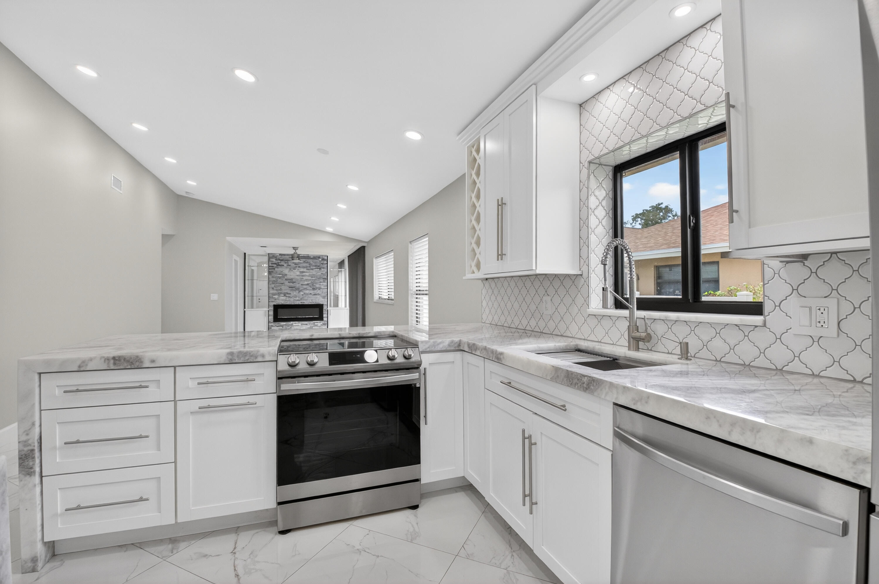 8216 Sweetbriar Way Boca Raton, FL 33496 - Photo 22 of 56 a kitchen with a stove sink and cabinets