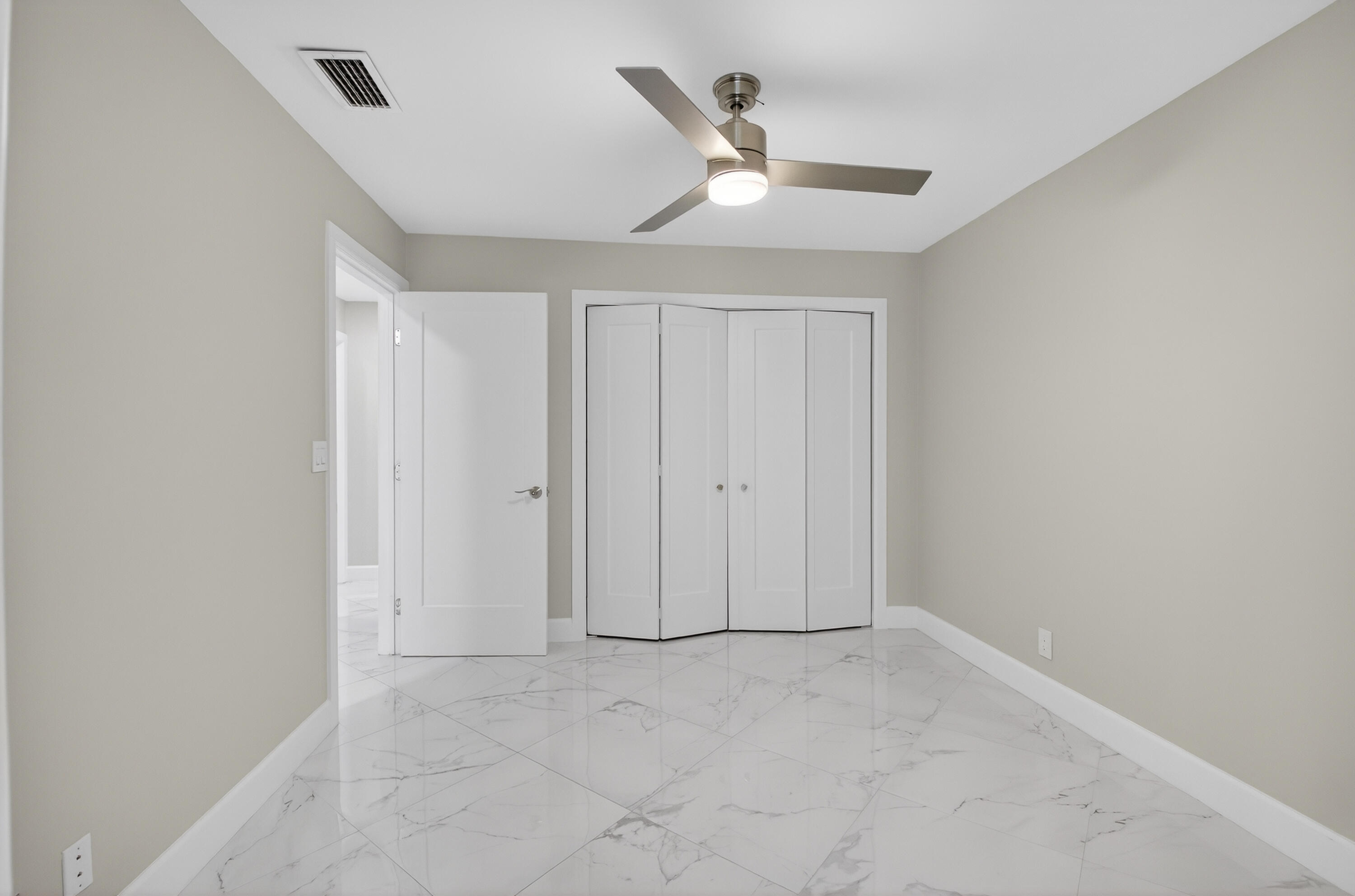 8216 Sweetbriar Way Boca Raton, FL 33496 - Photo 24 of 56 an empty room with a ceiling fan