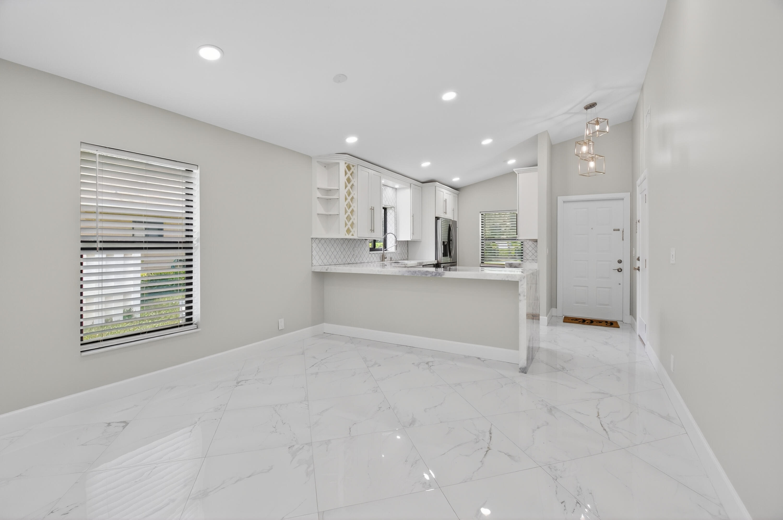 8216 Sweetbriar Way Boca Raton, FL 33496 - Photo 5 of 56 a view of an empty room with kitchen and window