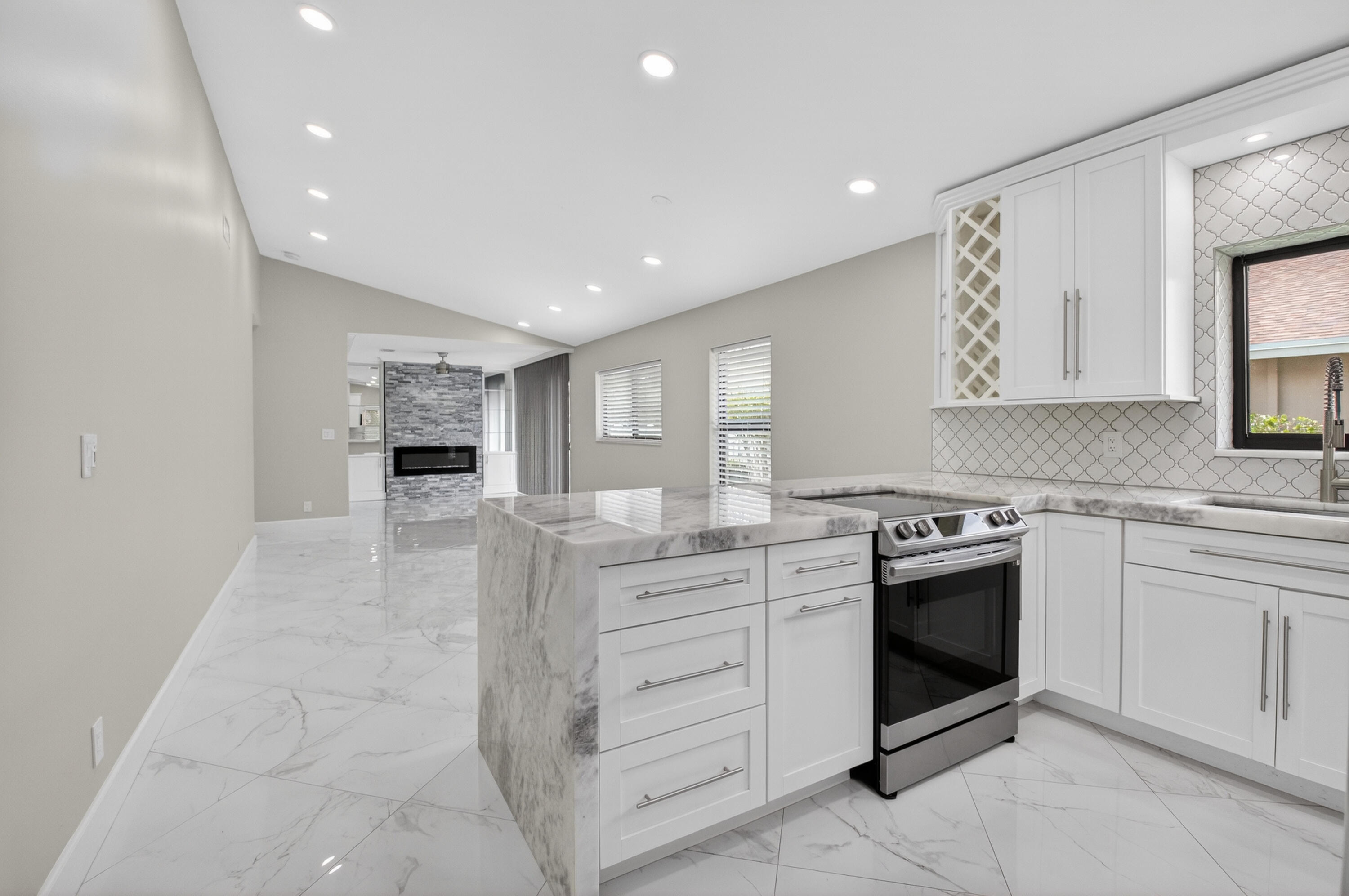 8216 Sweetbriar Way Boca Raton, FL 33496 - Photo 6 of 56 a kitchen with stainless steel appliances granite countertop a stove and a sink
