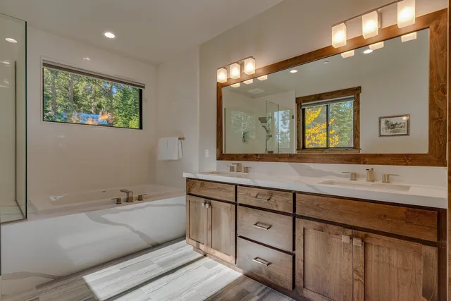 a spacious bathroom with a double vanity sink and a large mirror