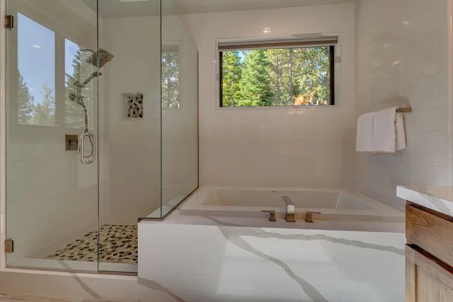 a bathroom with a bathtub and shower
