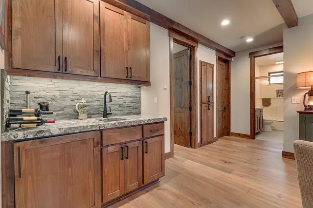 a kitchen with stainless steel appliances granite countertop a refrigerator and a sink