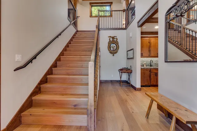 a view of an entryway with wooden floor and stairs
