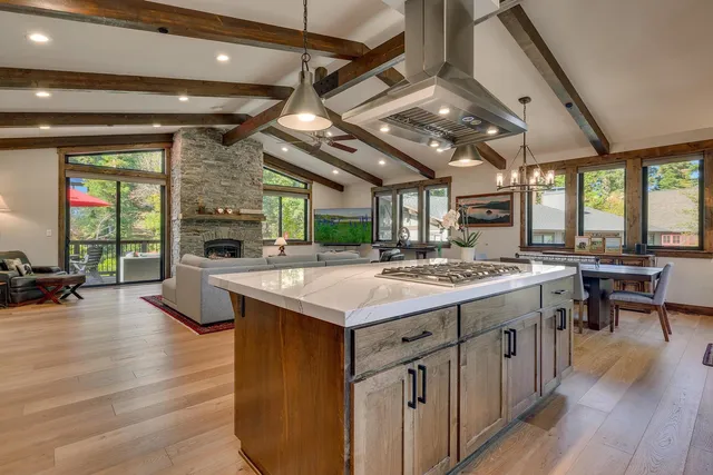 a kitchen with a stove and a wooden floor