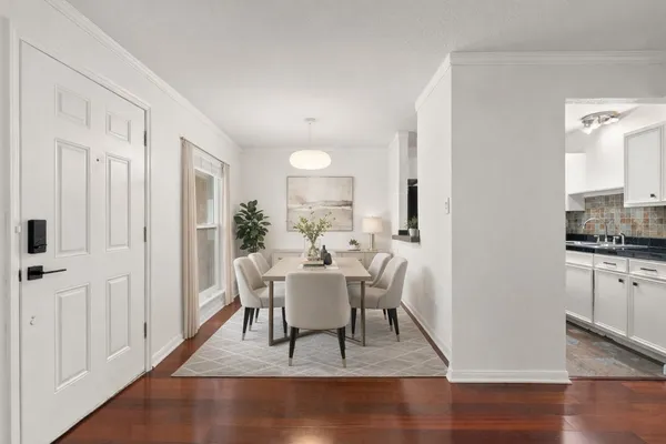 a view of a dining room with furniture window and wooden floor