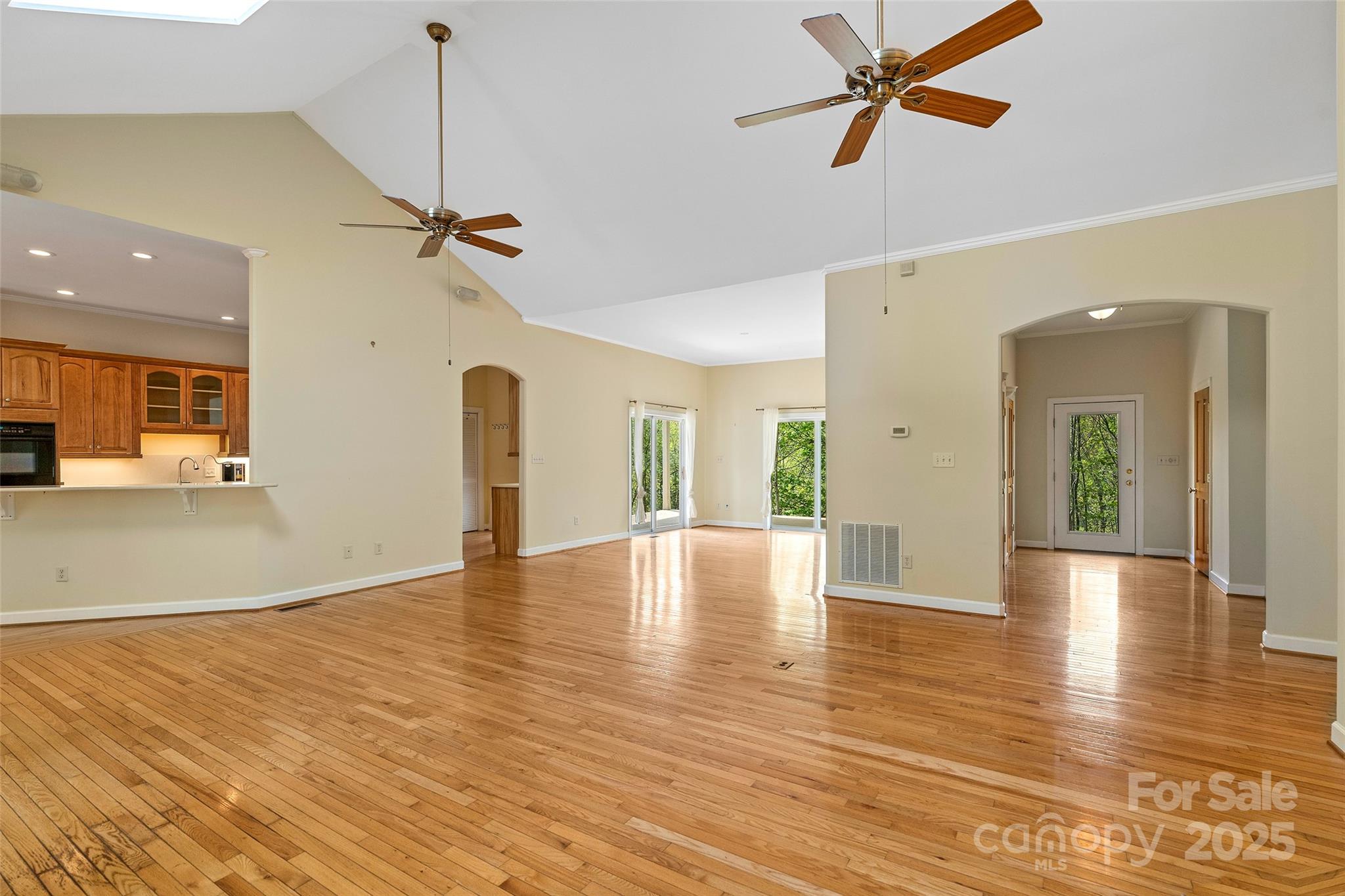 80 Ivy Cove Road Fairview, NC 28730 - Photo 18 of 48 a view of an empty room with wooden floor and a ceiling fan