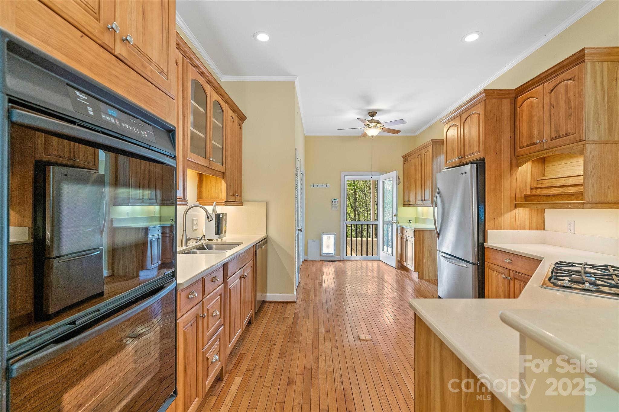 80 Ivy Cove Road Fairview, NC 28730 - Photo 22 of 48 a large kitchen with stainless steel appliances wooden floor and a large window