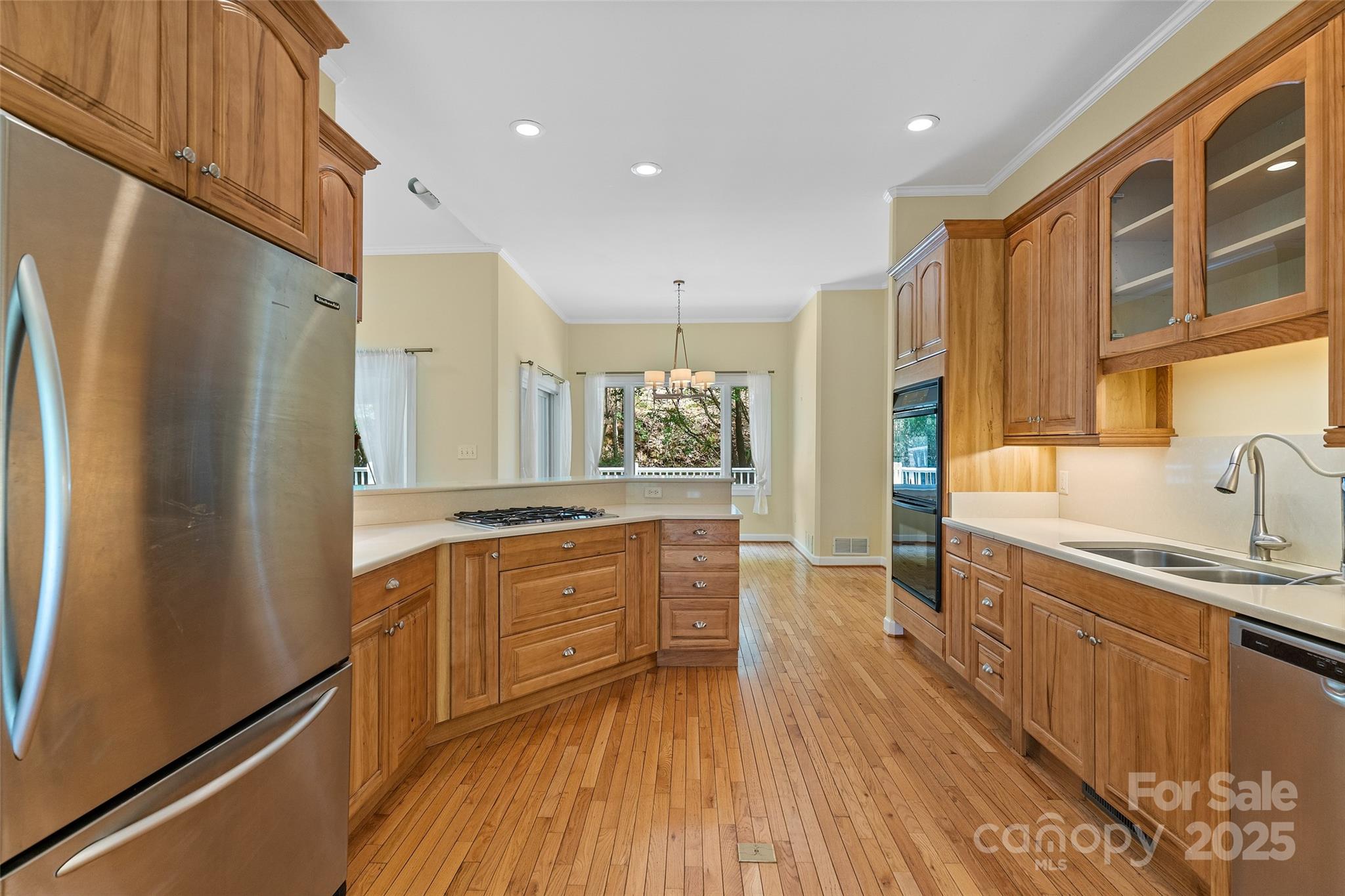 80 Ivy Cove Road Fairview, NC 28730 - Photo 23 of 48 a kitchen with stainless steel appliances granite countertop a refrigerator a sink dishwasher a stove and white countertops with wooden floor