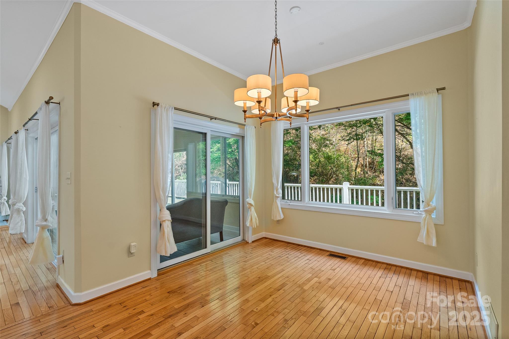 80 Ivy Cove Road Fairview, NC 28730 - Photo 26 of 48 a view of an empty room with wooden floor and a window