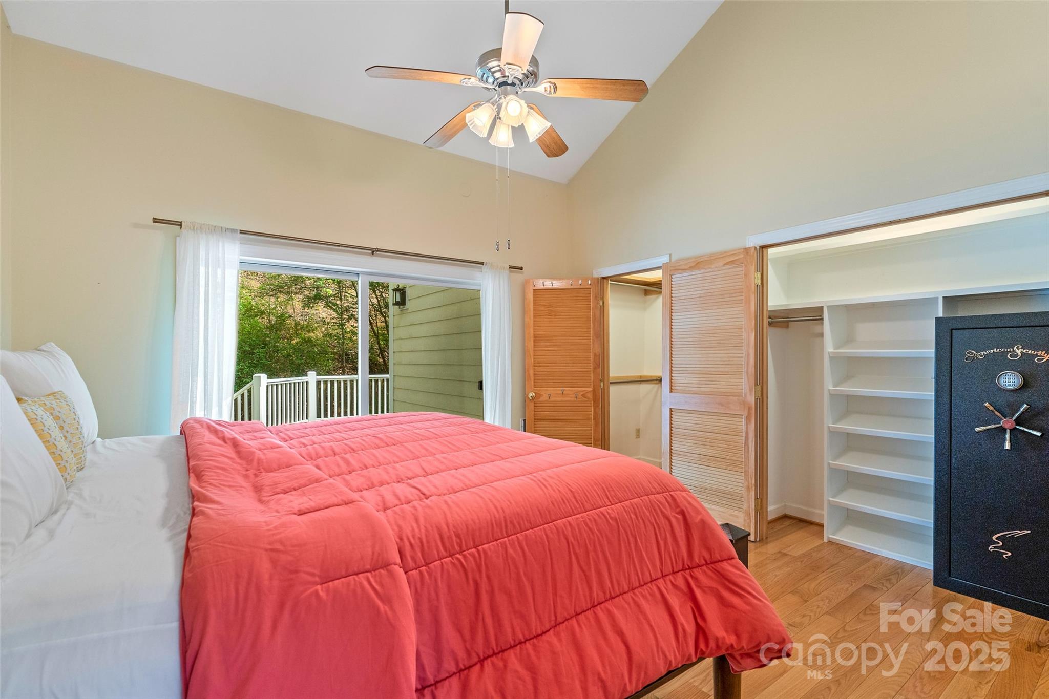 80 Ivy Cove Road Fairview, NC 28730 - Photo 46 of 48 a bedroom with a large bed and a chandelier