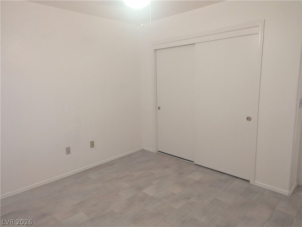 9433 Quail Ridge Drive Las Vegas, NV 89134 - Photo 13 of 23 Crisp white walls and durable plank flooring define this bedroom's adaptable space.
