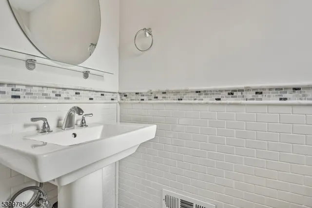 a bathroom with a sink a mirror and a shower