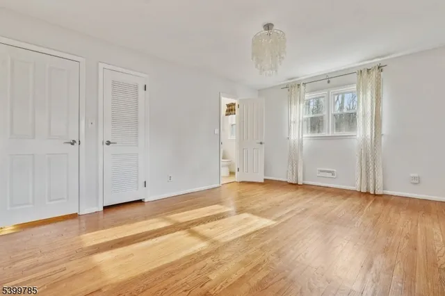 a view of an empty room and wooden floor